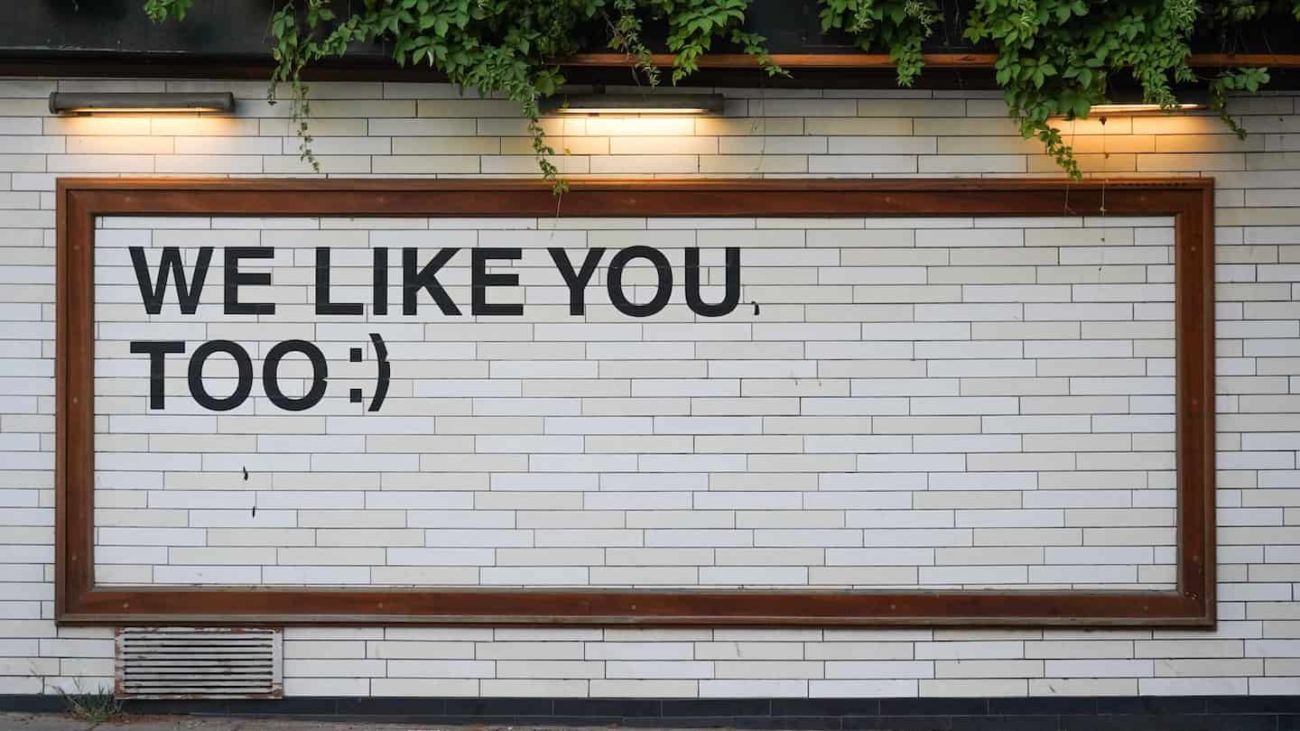Picture of a wall with We like you too written